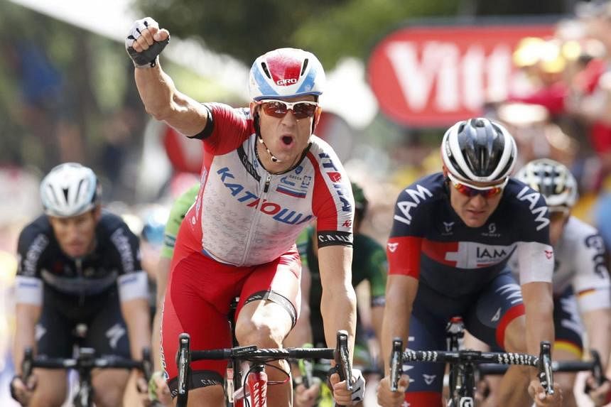 Katusha team rider Alexander Kristoff of Norway celebrates as he crosses the finish line to win the 222km 15th stage of the Tour de France cycling race between Tallard and Nimes on July 20, 2014. -- PHOTO: REUTERS