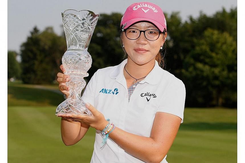 Lydia Ko of New Zealand holds the trophy after winning the the 2014 Marathon Classic presented by Owens Corning and O-I at Highland Meadows Golf Club&nbsp;in Sylvania, Ohio&nbsp;on July 20, 2014. -- PHOTO: AFP