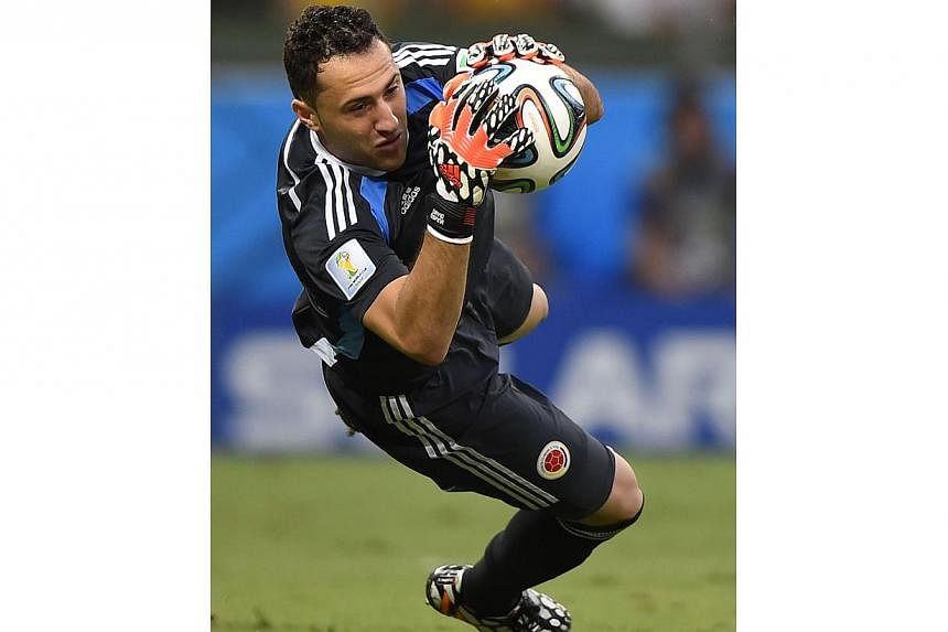 Colombia's goalkeeper David Ospina makes a save during the quarter-final football match between Brazil and Colombia at the Castelao Stadium in Fortaleza during the 2014 FIFA World Cup on July 4, 2014. -- PHOTO: AFP