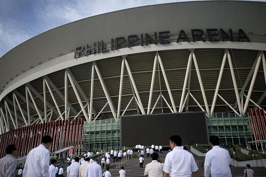Members of Iglesia ni Cristo (Church of Christ) are seen in front of the newly built dome in Bocaue, Bulacan, north of Manila, on July 20, 2014.&nbsp;&nbsp;-- PHOTO: AFP&nbsp;