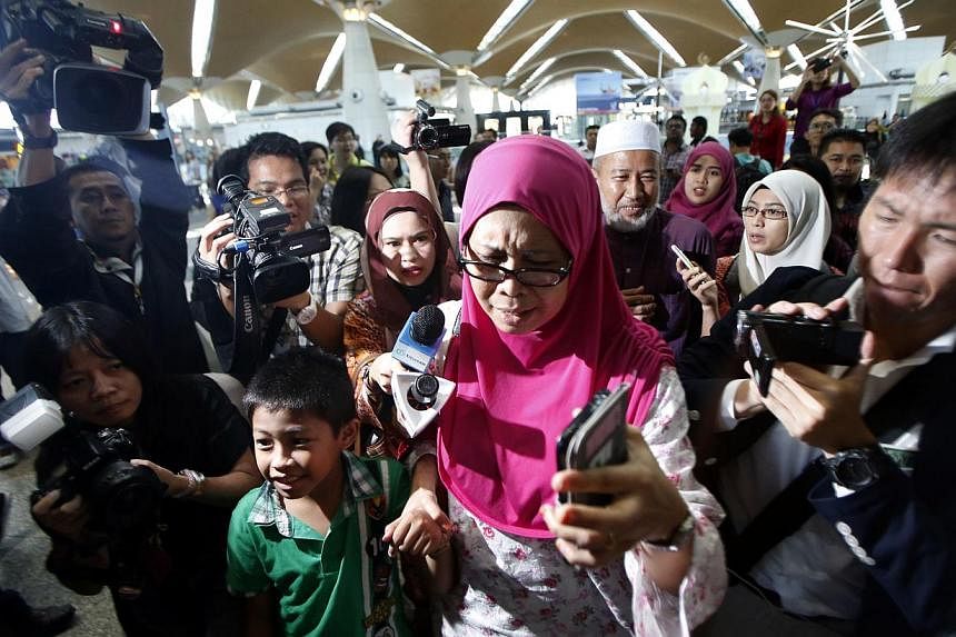 A Malaysian family arrives to confirm the news that their relatives were on board the Malaysian Airlines MH17 at the Kuala Lumpur International Airport in Sepang on July 18, 2014.&nbsp;Malaysia Airlines said it will provide US$5,000 (S$ 6,200) to eac