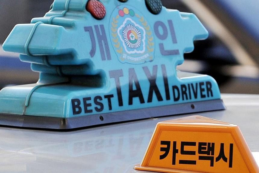 A file photo taken January 25, 2010 shows a South Korean taxi in Seoul.&nbsp;South Korea's capital Seoul said Monday, July 21, 2014 it planned to ban the smartphone car-hailing service Uber, saying it raised passenger safety issues and threatened the
