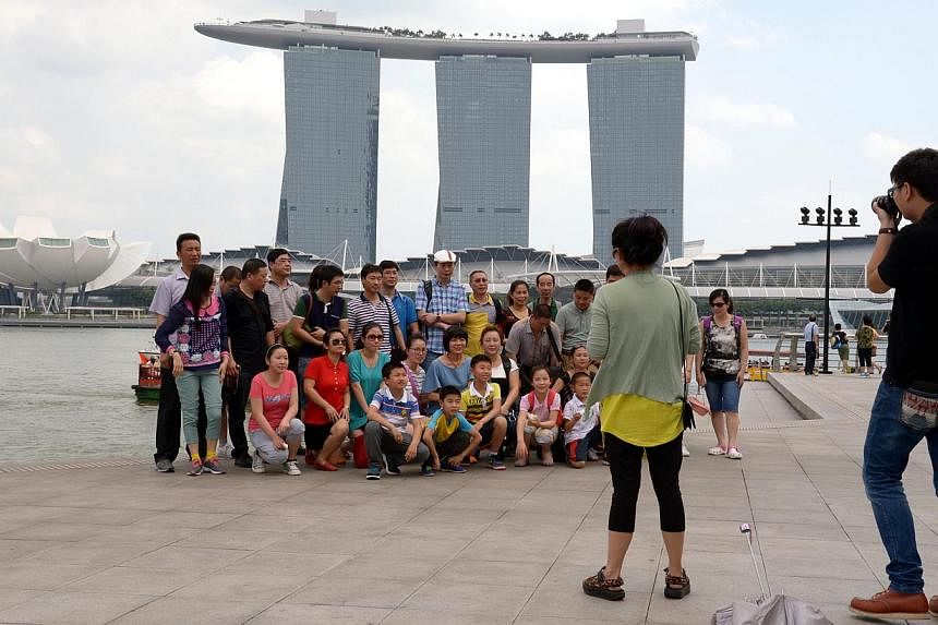 Tourists gathering for a shot in front of Marina Bay Sands, an integrated resort fronting Marina Bay in Singapore.&nbsp;Tourists spent $6 billion here for the first quarter of this year, up five per cent compared to last year, according to figures re