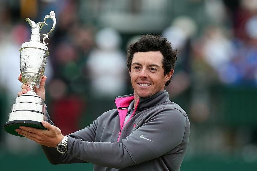 Northern Ireland's Rory McIlroy holds up the Claret Jug after winning the 2014 British Open Golf Championship at Royal Liverpool Golf Course in Hoylake, north west England on July 20, 2014. -- PHOTO: AFP