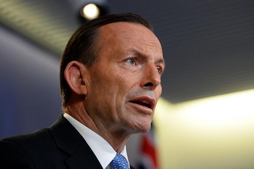 Australian Prime Minister Tony Abbott demanded on Sunday that the bodies of those killed when Malaysia Airlines Flight MH17 crashed be "treated with respect" and said he feared interference with evidence would continue. -- PHOTO: AFP