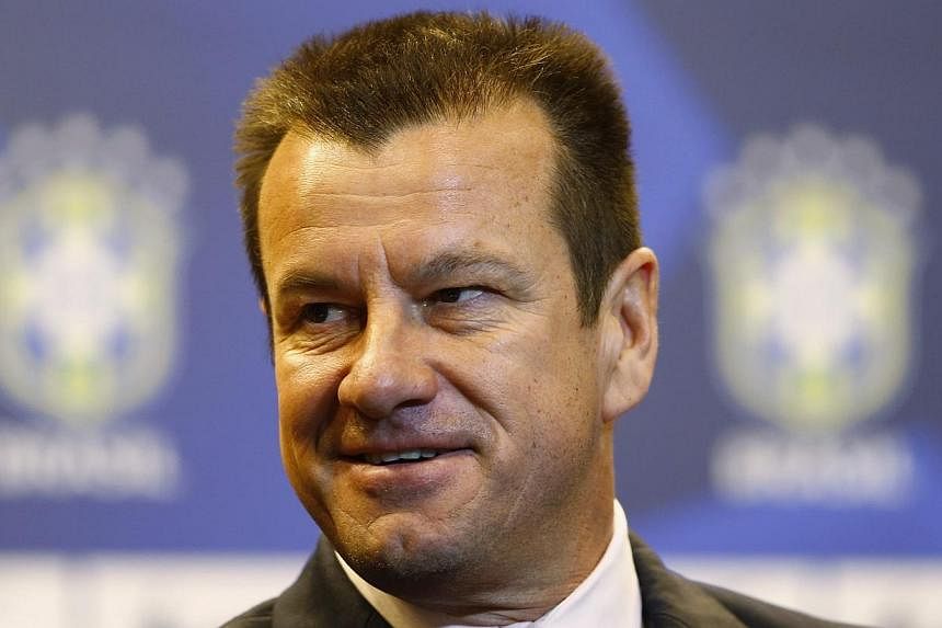 Brazil's new manager Dunga arrives at a news conference in Rio de Janeiro on July 22, 2014.&nbsp;Dunga won the World Cup as a player for Brazil and now the country is giving him a second chance to get the trophy as a coach. -- PHOTO: REUTERS
