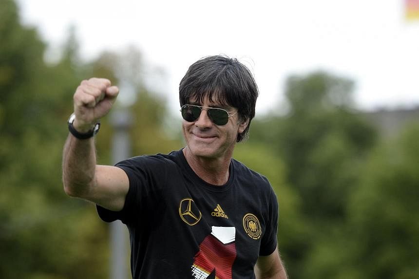 Germany's coach Joachim Loew celebrates their Fifa World Cup title at Berlin's Brandenburg Gate. Loew is to be made an honorary citizen of his hometown of Schoenau im Schwarzwald, the town mayor said on Tuesday, July 22, 2014. -- PHOTO: AFP