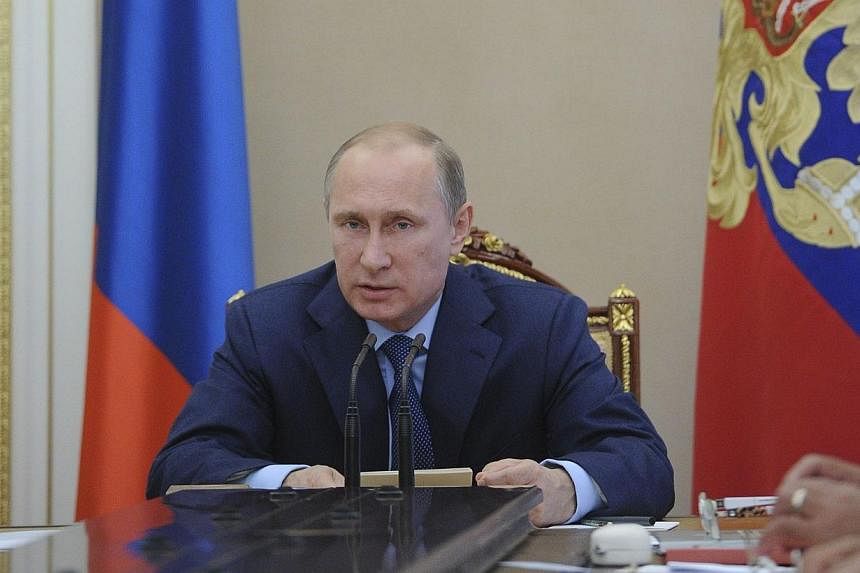 Russian President Vladimir Putin heads a meeting of the Security Council in Moscow's Kremlin on July 22, 2014. Russian President Vladimir Putin promised Tuesday, July 22, 2014, to do everything possible to influence pro-Russian separatists in eastern
