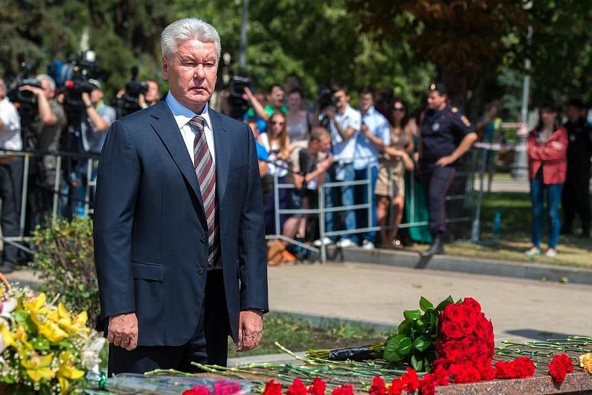 Moscow mayor Sergei Sobyanin lays flowers at the entrance to Park Pobedy metro station on July 16, 2014, the day after the devastating train crash in Moscow.&nbsp;Mr Sobyanin&nbsp;on July 22 announced he had fired the head of the capital's metro over