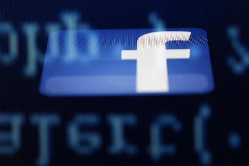 A photo illustration of a Facebook logo on an iPad. Australia's consumer watchdog has warned people to be wary of scams seeking to take advantage of the Malaysia Airlines MH17 tragedy, saying false Facebook profiles had already been set up. -- PHOTO: