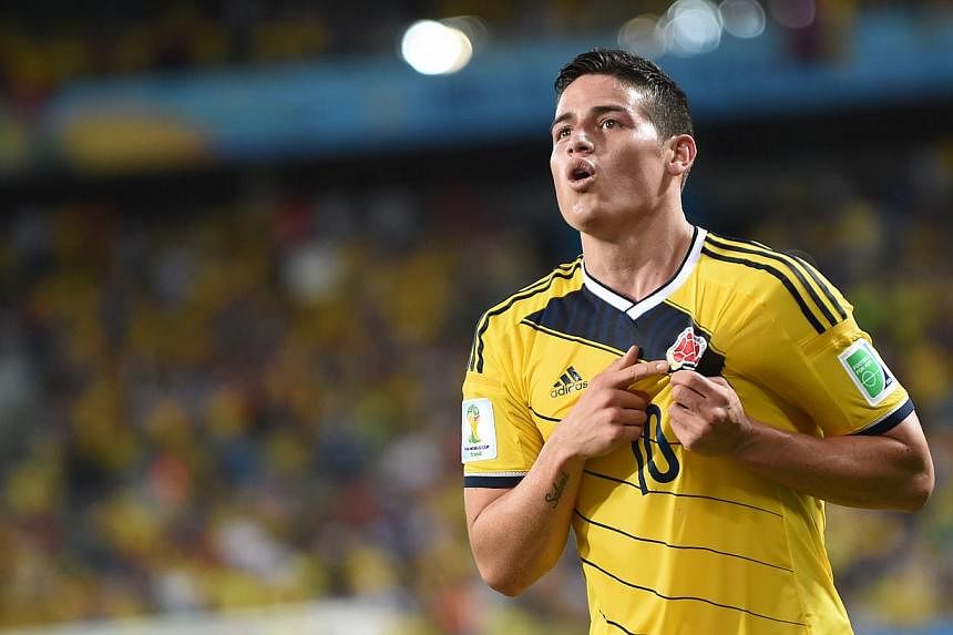 Colombia's midfielder James Rodriguez celebrates after scoring Colombia's fourth goal during the Group C football match between Japan and Colombia at the Pantanal Arena in Cuiaba during the 2014 FIFA World Cup on June 24, 2014. -- PHOTO: AFP