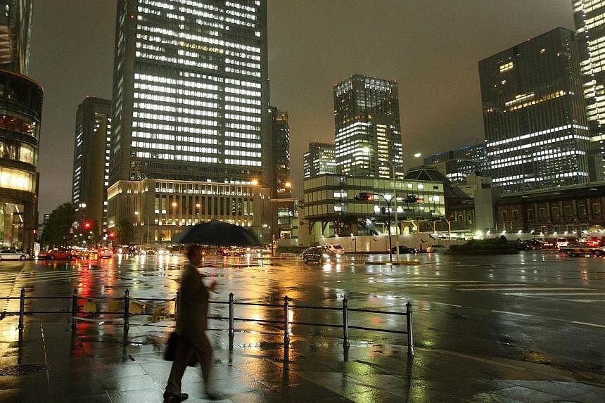 The Japanese government has slightly lowered its economic growth forecast for the current fiscal year to March 2015 due to sluggish exports and a larger-than-expected pullback in demand after the April sales-tax hike, Cabinet Office estimates show. -