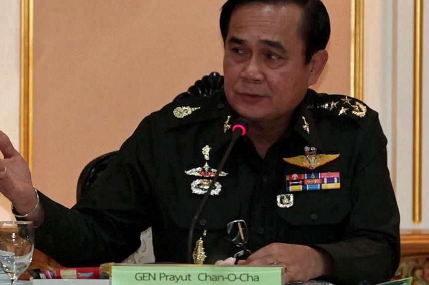 Thai junta chief General Prayut Chan-O-Cha gesturing as he speaks during a meeting with businessmen at the Army headquarter in Bangkok on June 19, 2014.&nbsp;Thailand's junta chief is set to meet the king on Tuesday, July 22, 2014, to win approval fo