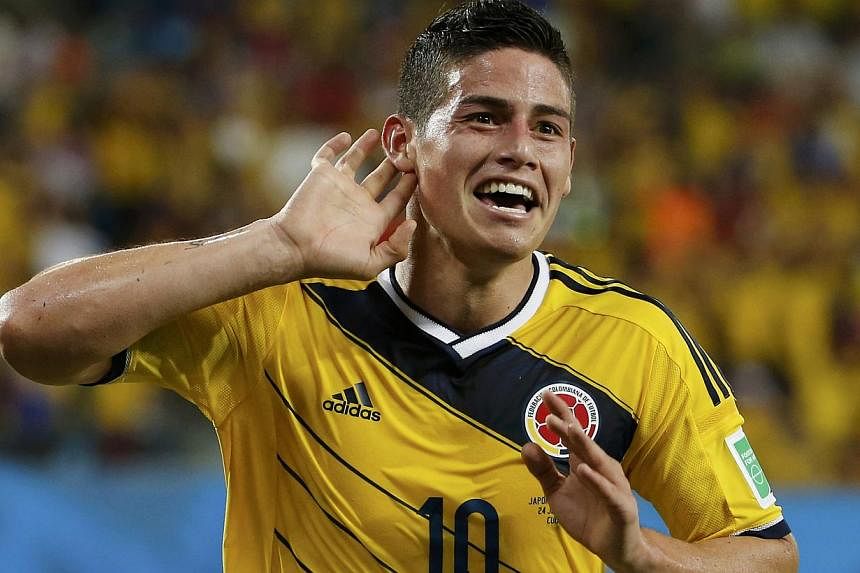 Colombia's James Rodriguez celebrates after scoring a goal during the 2014 World Cup Group C soccer match between Japan and Colombia at the Pantanal arena in Cuiaba on June 24, 2014.&nbsp;Real Madrid have signed Rodriguez from Monaco on a six-year co