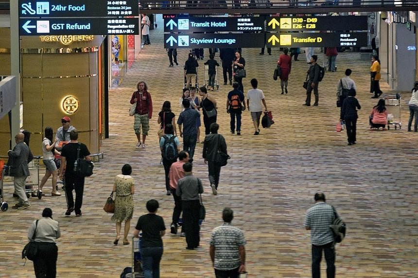 Changi Airport handled 4.65 million passengers in June, the highest for any month so far this year, but lower than a year ago. -- PHOTO: AFP