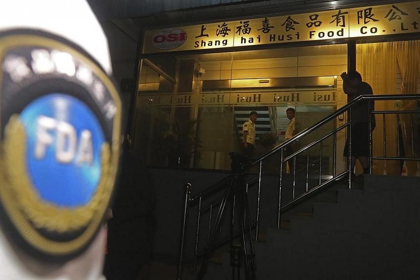 Officers from Shanghai Food and Drug Administration conduct a seizure at Husi Food factory in Shanghai on July 20, 2014.&nbsp;Chinese police on Wednesday, July 23, 2014, detained five people from a unit of US food supplier OSI Group, officers said, i