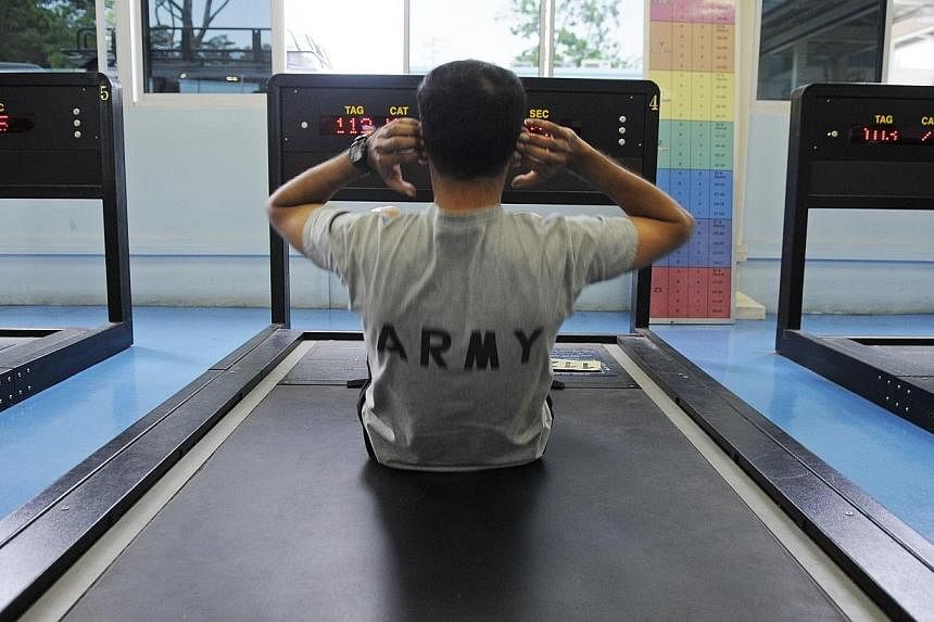 An NS man at the sit-ups station at Maju Camp.&nbsp;The Individual Physical Proficiency Test (IPPT) has been revised with the scrapping of the Standing Broad Jump, shuttle run and pull-up stations. -- ST PHOTO: AIDAH RAUF&nbsp;