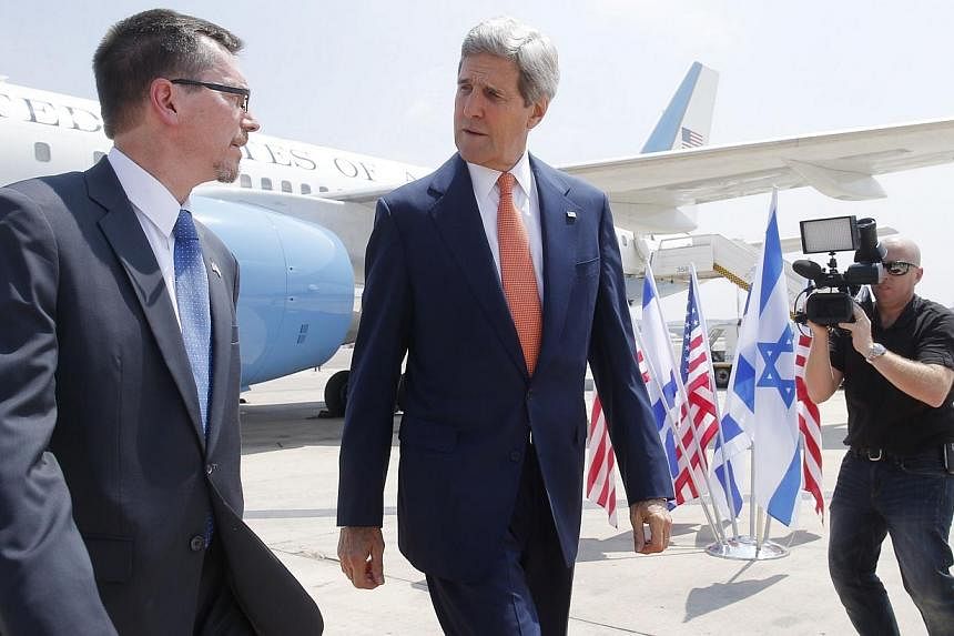 US Secretary of State John Kerry (centre) walks with US embassy Deputy Chief of Mission Bill Grant at Ben Gurion airport as he arrives in Israel on July 23, 2014.&nbsp;Washington's top diplomat flew into Tel Aviv Wednesday, defying a US flight ban, t