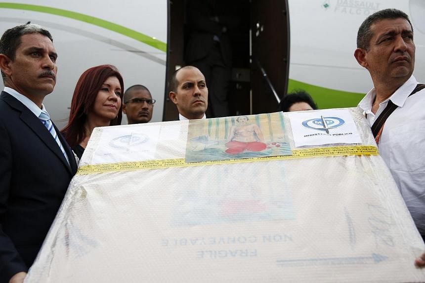 Authorities show the box containing a painting of French master Henri Matisse, known as Odalisque In Red Pants (Odalisque a la Culotte Rouge), to the media at Maiquetia International Airport in Caracas on July 7, 2014.&nbsp;-- PHOTO: REUTERS
