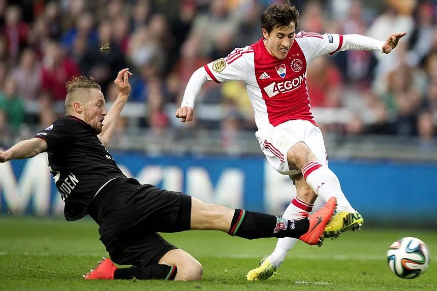 Ajax player Bojan Krkic (right) kicks the ball to score his team's second goal during the Dutch Eredivisie football match between Ajax Amsterdam and NEC Nijmegen, in Amsterdam, the Netherlands, on May 3, 2014. -- PHOTO: AFP