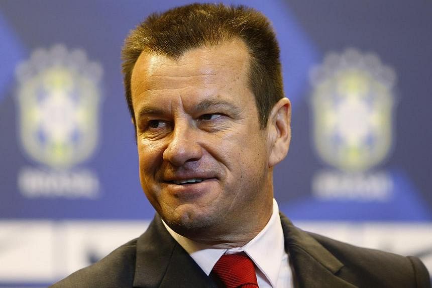 Brazil's new manager Dunga arrives at a news conference in Rio de Janeiro on July 22, 2014. -- PHOTO: REUTERS