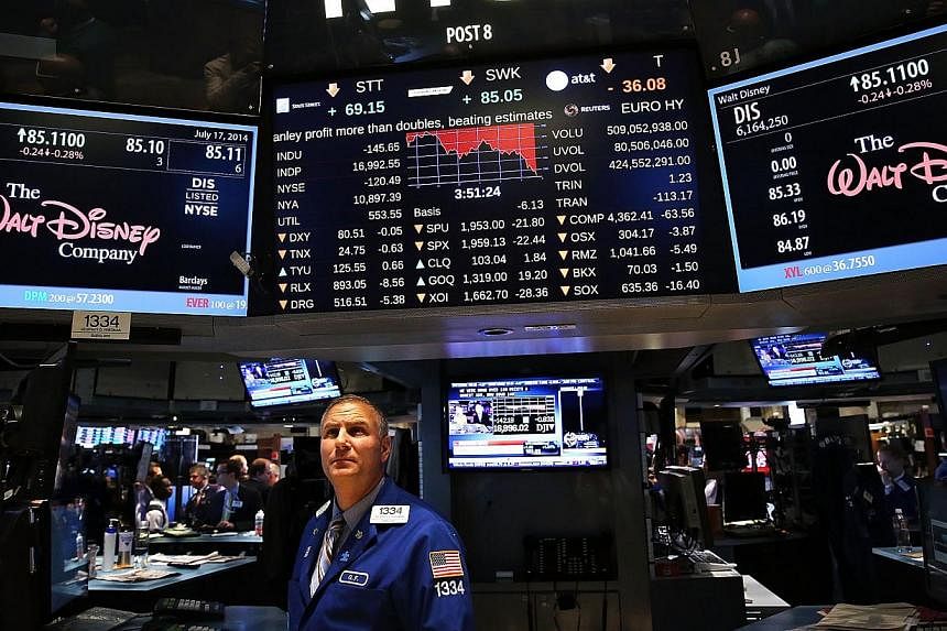 Traders work on the floor of the New York Stock Exchange (NYSE) in New York City on July 17, 2014. Computer systems containing the Wall Street Journal's news graphics were hacked by outside parties, according to the paper's publisher Dow Jones &amp; 