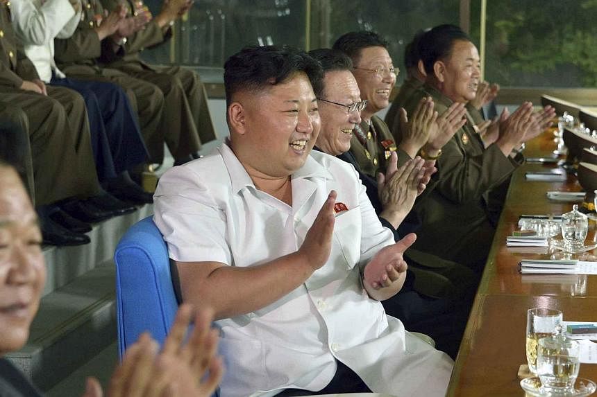 North Korean leader Kim Jong Un watches a match played by the North Korean men's national soccer team, which will take part in the 17th Asian Games, in this undated photo released by North Korea's Korean Central News Agency (KCNA) in Pyongyang on Jul