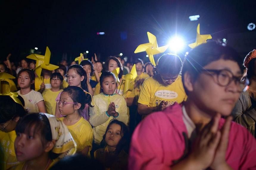 People attend a rally for victims of the Sewol ferry in central Seoul on Thursday, July 24, 2014.&nbsp;Thousands of people rallied in Seoul on Thursday, 100 days after South Korea's ferry disaster, to push for an independent inquiry into the tragedy 