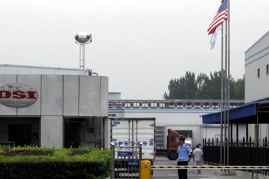 A security personnel stands guard in front of an OSI's food processing plants in Langfang, Hebei province, July 23, 2014. Shanghai police said on Wednesday they detained five people in an investigation into a Chinese-based supplier of foreign fast-fo