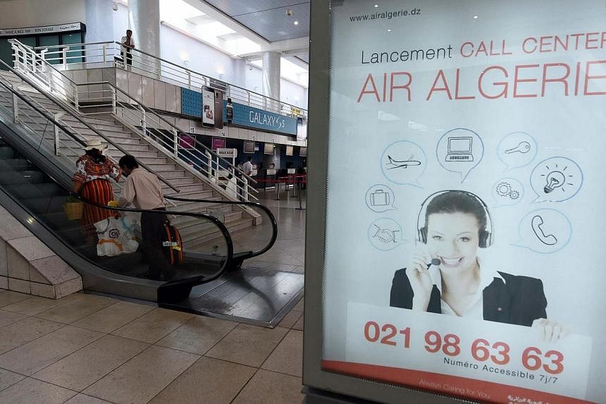 A picture taken on July 24, 2014 shows an ad for Air Algerie call center at the Houari-Boumediene International Airport in Algiers.&nbsp;Many French nationals are thought to be on board an Air Algerie jet which went missing after taking off from Burk