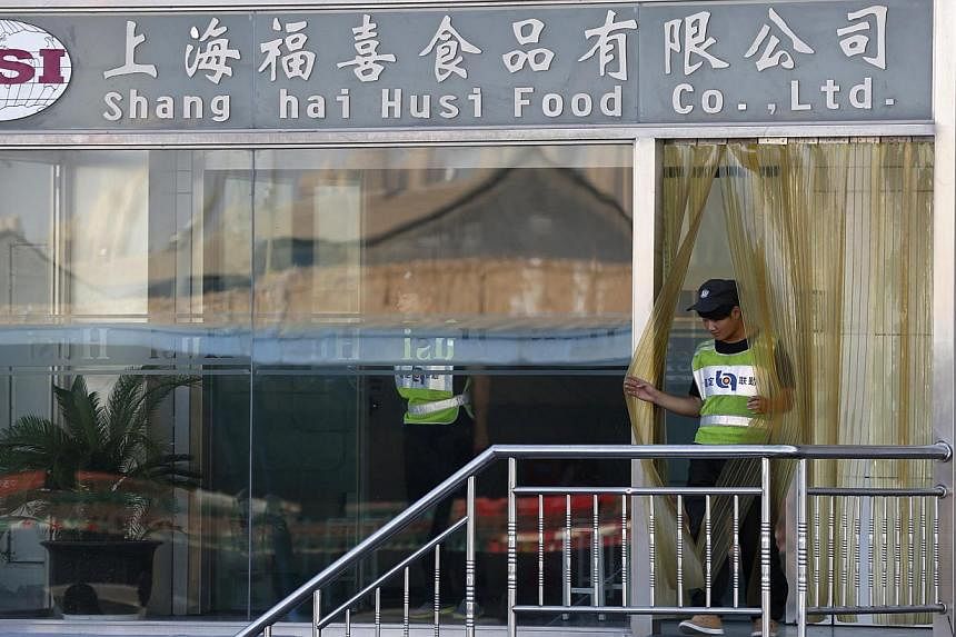 A man walks out of the entrance of OSI Group's Husi Food factory in Shanghai on July 23, 2014. OSI Group, the US food supplier at the centre of an expired meat scandal in China, has apologised. KFC and Pizza Hut's parent company said it would stop us