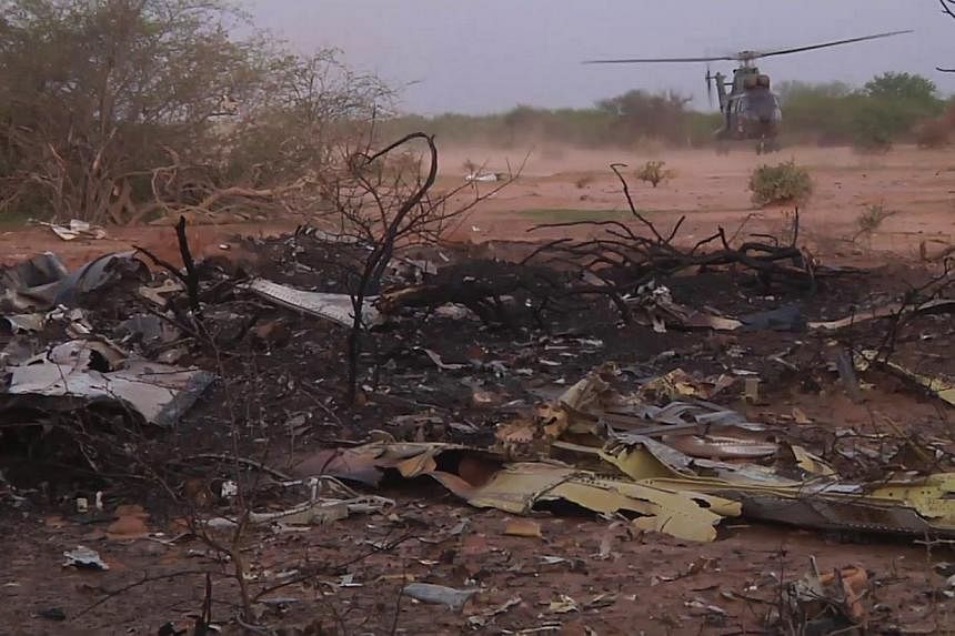 A undated handout released on July 25, 2014 by ECPAD, the French Army Communication Audiovisual office, shows the crash site of Air Algerie flight AH5017 near the northern Mali town of Gossi. -- PHOTO: REUTERS