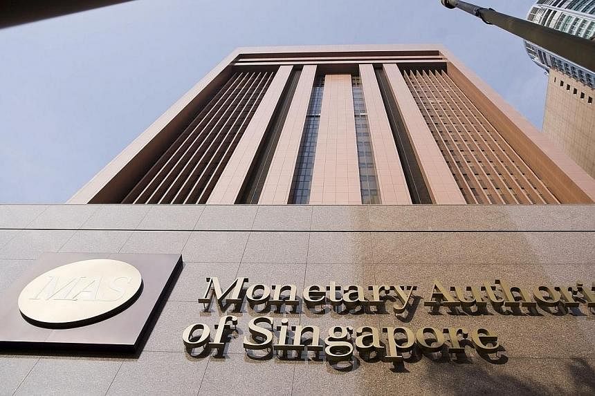 The Monetary Authority of Singapore stands in Singapore on Wednesday, April 29, 2009.&nbsp;Companies took advantage of continued low interest rates last year to issue more debt, the Monetary Authority of Singapore said yesterday. -- PHOTO: BLOOMBERG
