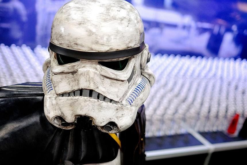 A Stormtrooper stands by a display of Star Wars figurines in the exhibitor hall during the 45th annual San Diego Comic-Con&nbsp;in San Diego, California&nbsp;on July 24, 2014. -- PHOTO: AFP