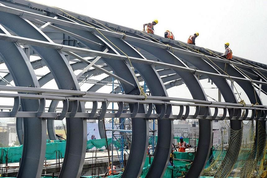 A file picture of Indian Hyderabad Metro Rail (HMR) labourers work at a construction site in Hyderabad. India's new right-wing government under Prime Minister Narendra Modi has promised a new era of greater opportunities and&nbsp;stable and simple ta