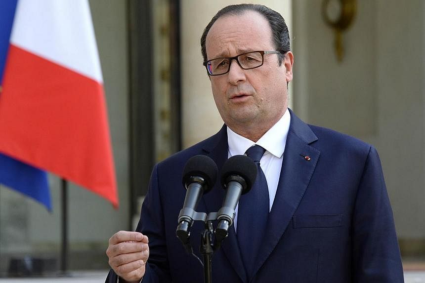 French President Francois Hollande delivers a statment to the press at the Elysee Palace in Paris on July 24, 2014, after an Air Algerie plane with about 110 passengers, including 50 French nationals, went missing after taking off from Burkina Faso f