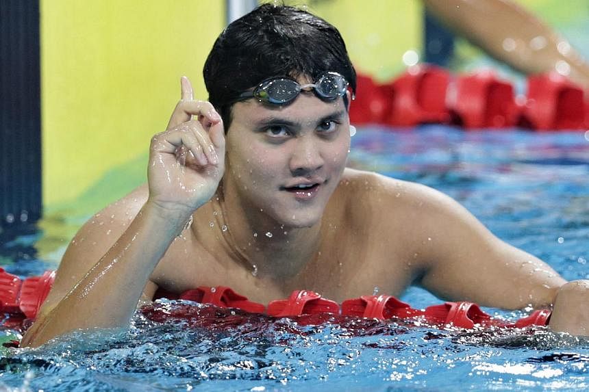 National swimmer Joseph Schooling gestures after winning the gold medal in the men's 200m individual medley at the 27th SEA Games held in Naypyidaw's Wunna Theikdi Swimming Complex, Myanmar, on Dec 13, 2013. -- ST PHOTO: KEVIN LIM