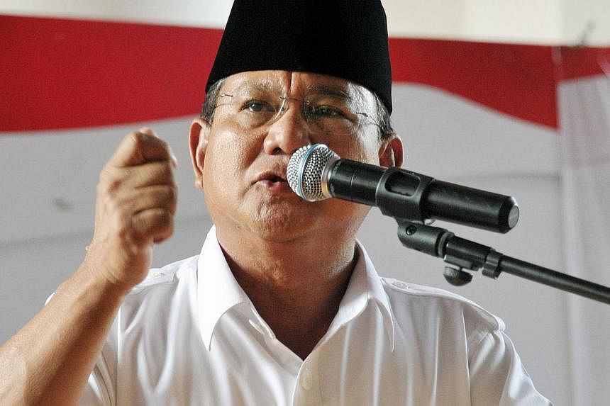 Defeated presidential candidate Prabowo Subianto and his running mate Hatta Rajasa on Friday filed a challenge to the election result at the Constitutional Court, but not before railing against the Election Commission (KPU). -- PHOTO: AFP&nbsp;