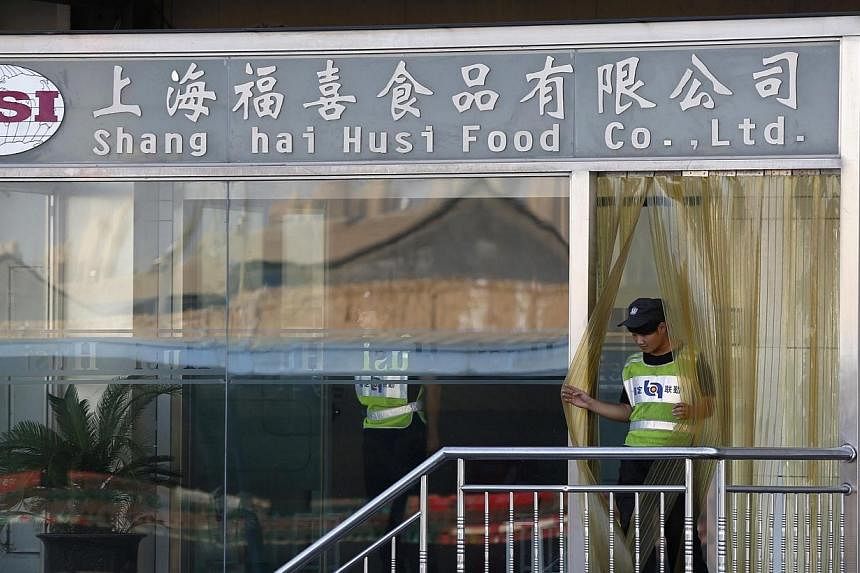 A man walks out of the entrance of Husi Food factory in Shanghai on July 23, 2014.&nbsp;Regulators in Shanghai have found that a scandal-hit China-based food supplier forged production dates on some of its products and sold them after their expiry, t