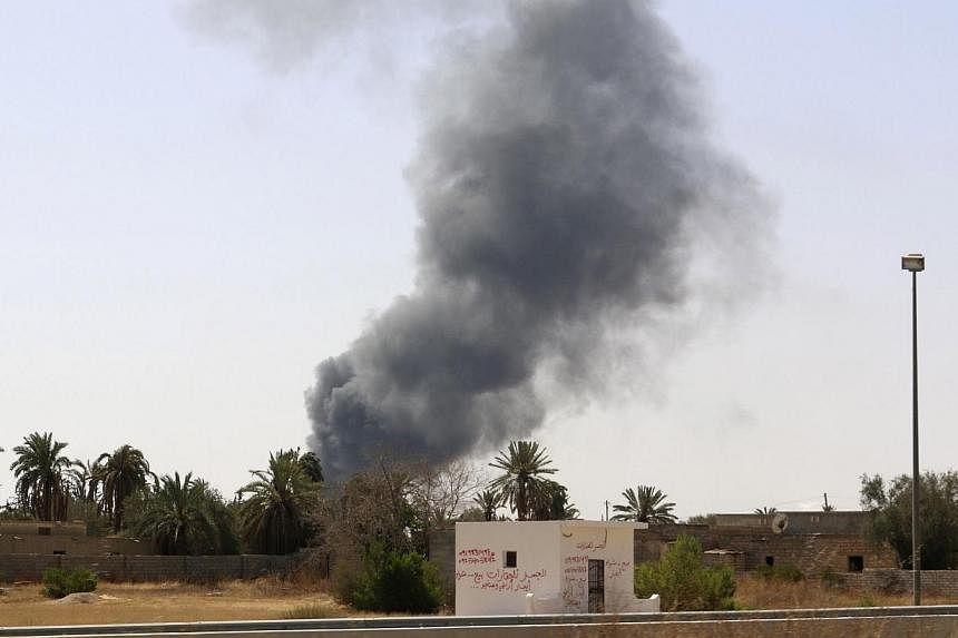 Smoke rises over the Airport Road area after heavy fighting between rival militias broke out near the airport in Tripoli on July 25, 2014.&nbsp;The United States ordered on Saturday's evacuation of its embassy in Libya due to a "very real risk" to pe