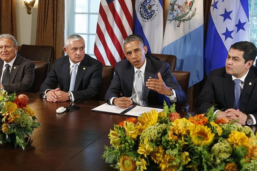 US President Barack Obama (second right) hosts a meeting with El Salvador's President Salvador Sanchez Ceren (left), Guatemala's President Otto Perez Molina (second left) and Honduras' President Juan Orlando Hernandez, to discuss the flow of undocume