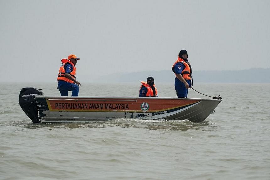 A file picture taken on June 19, 2014 shows Malaysian search and rescue teams carrying out a search operation near the area where a boat carrying Indonesian illegal migrants sank overnight in seas near Banting. Malaysia is offering illegal Indonesian