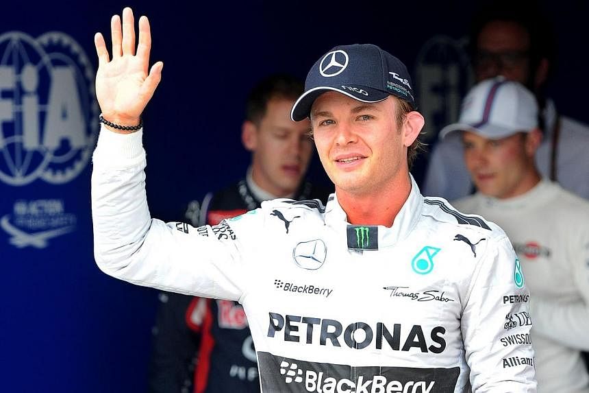 Mercedes' German driver Nico Rosberg celebrates after the qualifying session of the Hungarian Formula One Grand Prix at the Hungaroring circuit in Budapest on July 26, 2014. -- PHOTO: AFP