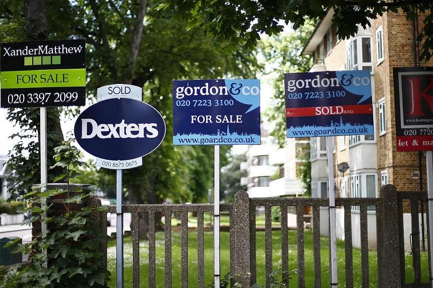 Estate agents boards are lined up outside houses in south London June 3, 2014. London real-estate is now on average 20 per cent more expensive than before the onset of the financial crisis. -- PHOTO: REUTERS