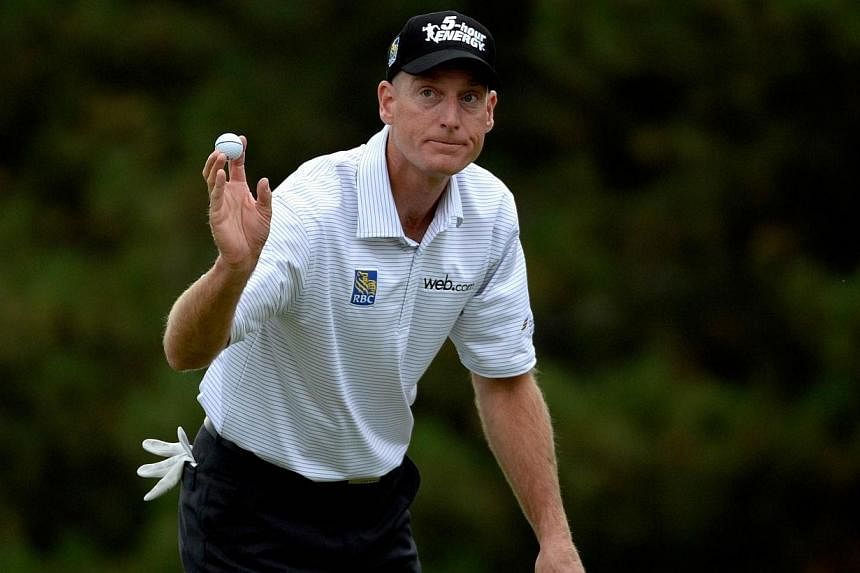 Jim Furyk acknowledges the crowd on the 18th green during the third round of the RBC Canadian Open at the Royal Montreal Golf Club on July 26, 2014 in Montreal, Quebec, Canada. -- PHOTO: AFP