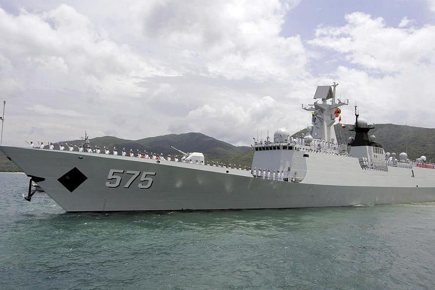 Chinese navy sailors waving as Chinese naval missile frigate Yueyang departs for an exercise at a military port in Sanya, Hainan province on June 9, 2014. -- FILE PHOTO: REUTERS