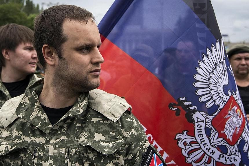 Pavel Gubarev, one of the leaders of the self-proclaimed Donetsk People's Republic, watches as fighters pledge an an oath during ceremony in the city of Donetsk on June 21, 2014.&nbsp;Pavel Gubarev&nbsp;said east Ukraine was a "de facto offshore zone