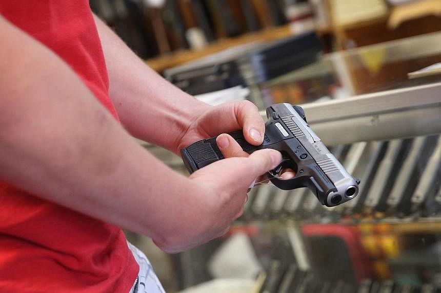 A federal judge on Saturday, July 26, 2014 ruled that the ban on citizens carrying handguns in public in the US capital is unconstitutional. -- PHOTO: AFP&nbsp;