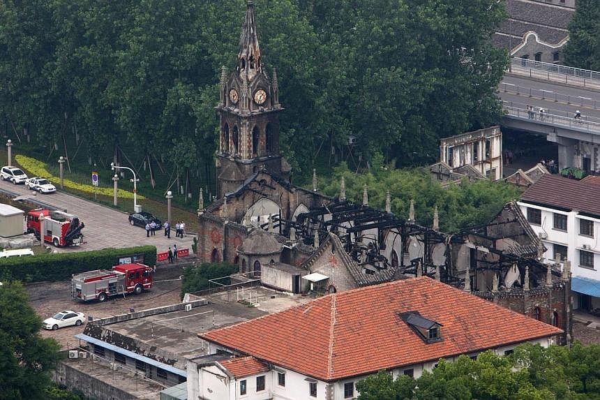 This overhead view shows firetrucks (bottom left) beside the Ningbo cathedral as firefighters put out a fire at the structure in Ningbo, in eastern China's Zhejiang province on Monday, July 28, 2014.&nbsp;A fire largely destroyed one of China's oldes