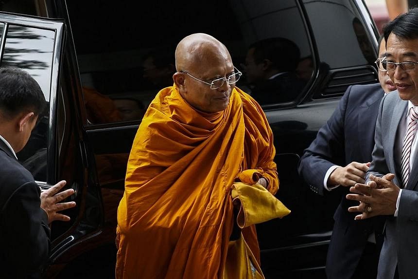 Former anti-government protest leader Suthep Thaugsuban (centre), who is now a Buddhist monk, arrives at the Criminal Court in Bangkok on Monday, July 28, 2014.&nbsp;The firebrand leader of months-long street protests which preceded Thailand's latest